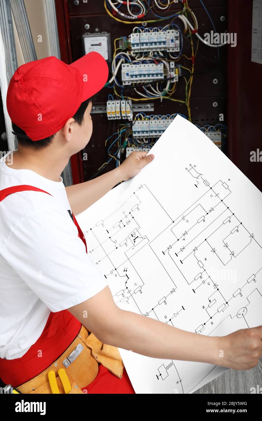 Electrician With Wiring Diagram Indoors Stock Photo Alamy