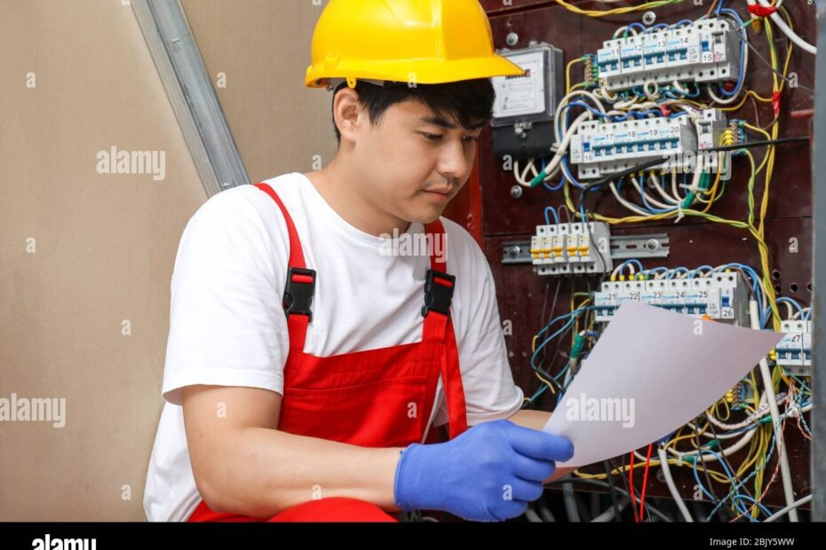 Electrician With Wiring Diagram Indoors Stock Photo Alamy